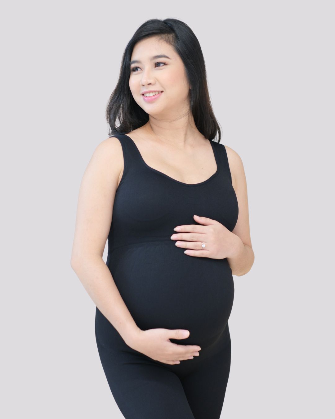Pregnant woman taking measurements for a sizing guide